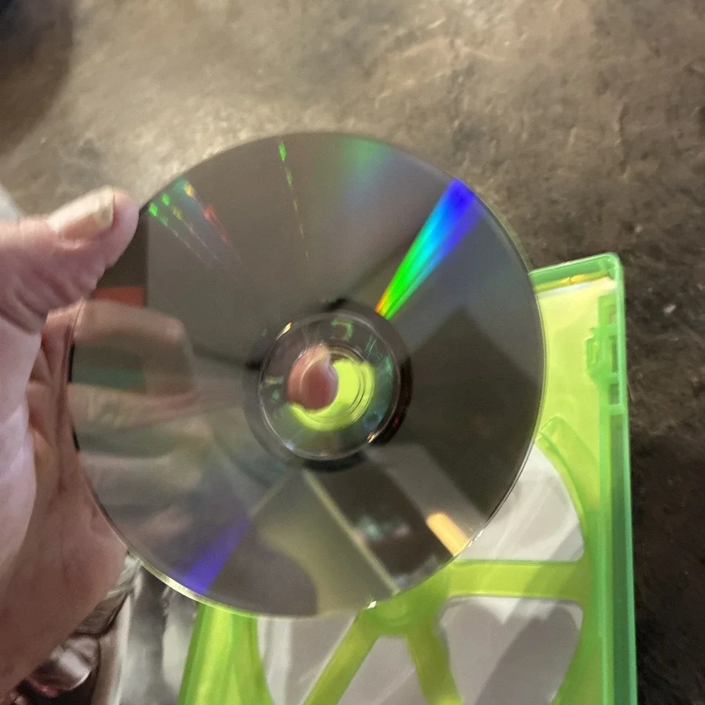 Three Xbox 360 Games, Assassin Creed, Battlefield, And Call Of Duty